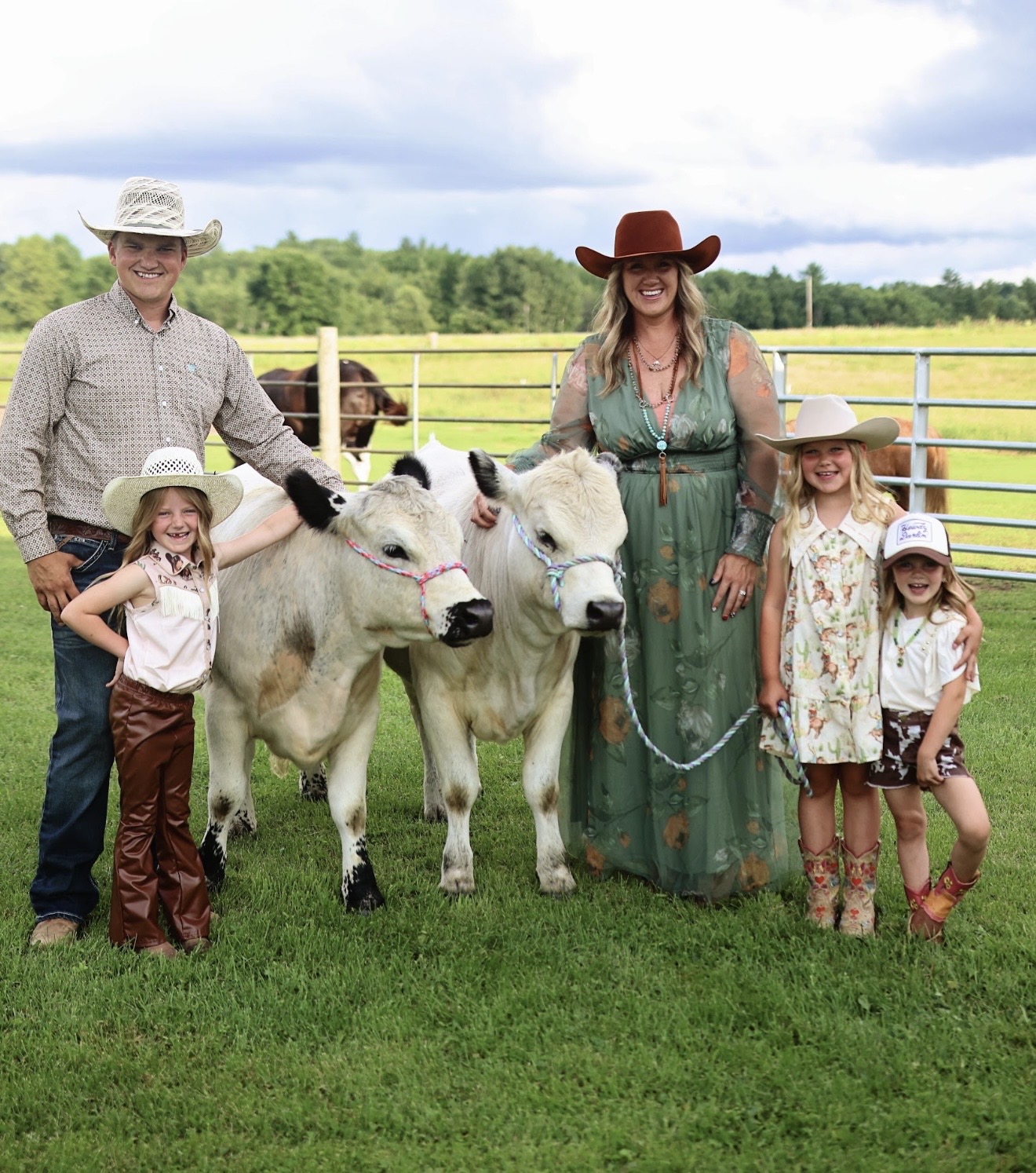 Kyle and Krista Knops with their three daughters and two of the farm cattle in Clayton, Wisconsin